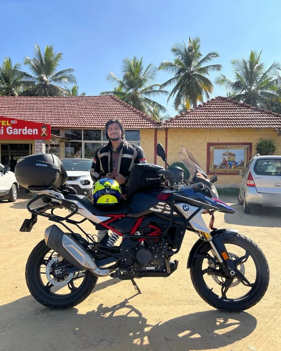 Sandeep in riding gear behind an adventure motorcycle