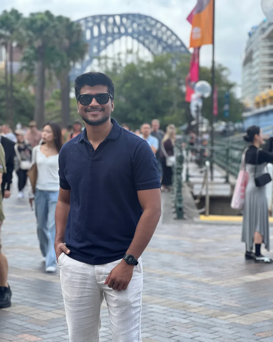 Sandeep at Circular Quay with the Sydney Harbour Bridge behind him